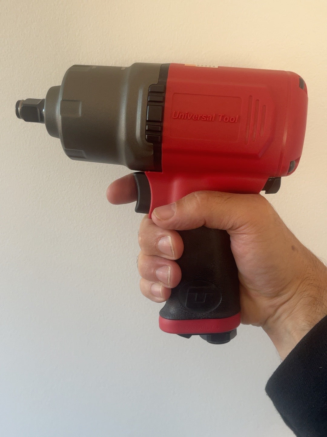 Actual UT8165R impact wrench in hand for scale