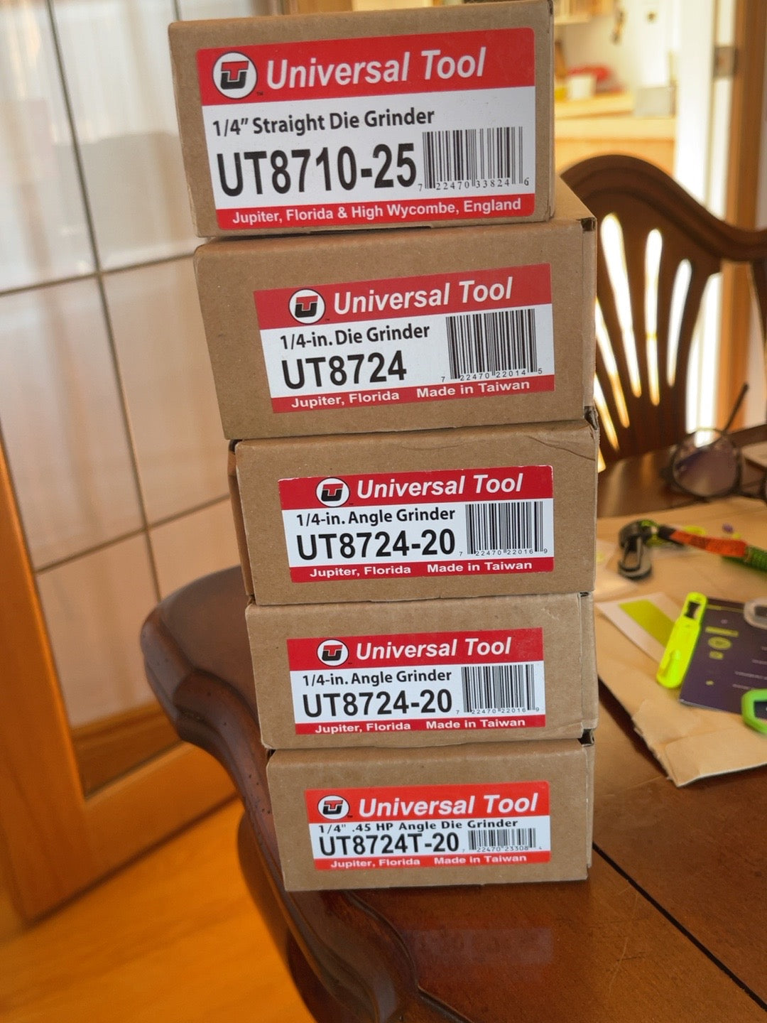 Actual Arclight clearance inventory group photo showing Universal Tool UT8710-25 carton with four other grinder cartons; not additional inventory